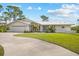 Charming single-story home featuring a two-car garage, well-manicured lawn, and a modern metal roof at 38 Riverfront Dr, Venice, FL 34293