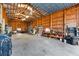 Inside the expansive garage with wooden walls, storage and tools line the walls at 38 Riverfront Dr, Venice, FL 34293