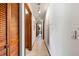 Hallway featuring tile floors, a tree mural, wood door frames, and recessed lighting at 38 Riverfront Dr, Venice, FL 34293