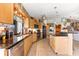Spacious kitchen featuring stainless steel appliances, granite countertops, and wooden cabinets at 38 Riverfront Dr, Venice, FL 34293