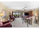 Spacious living room featuring comfortable seating, sliding glass doors, and neutral carpeting at 38 Riverfront Dr, Venice, FL 34293
