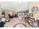 Open-concept living room with tiled flooring, large windows with a view, and neutral color palette at 38 Riverfront Dr, Venice, FL 34293