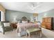 Comfortable main bedroom with a ceiling fan, plush carpet, and traditional furnishings at 38 Riverfront Dr, Venice, FL 34293