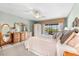 Main bedroom showing elegant mirrors, dressers, furnishings, and beautiful outdoor views at 38 Riverfront Dr, Venice, FL 34293