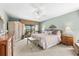 The main bedroom features a ceiling fan and a screened patio with tranquil views at 38 Riverfront Dr, Venice, FL 34293