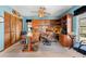 Home office with built-in shelving, wood desk, rolling chair, ceiling fan, and natural light at 38 Riverfront Dr, Venice, FL 34293