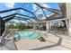 Backyard pool with an enclosed screen, next to an outside dining area at 38 Riverfront Dr, Venice, FL 34293