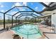 Inviting screened-in pool area surrounded by lush greenery at 38 Riverfront Dr, Venice, FL 34293