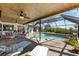 Relax by the screened in pool with lounge chairs and an outdoor dining set at 38 Riverfront Dr, Venice, FL 34293