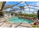 A kidney-shaped pool sits in the backyard, fully screened in for outdoor enjoyment at 38 Riverfront Dr, Venice, FL 34293