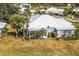 Single-story villa with screened porch and tropical landscaping at 450 Wexford Cir # 106, Venice, FL 34293