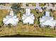 Three villas with white roofs, situated near a waterway at 450 Wexford Cir # 106, Venice, FL 34293