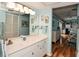 Clean bathroom with double vanity and view of bedroom at 450 Wexford Cir # 106, Venice, FL 34293