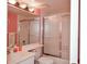 Bathroom with a tub shower combo, white vanity and pink walls at 450 Wexford Cir # 106, Venice, FL 34293