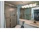 Bright bathroom with white vanity, shower, and updated fixtures at 450 Wexford Cir # 106, Venice, FL 34293