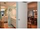 Clean bathroom with double vanity and access to dining room at 450 Wexford Cir # 106, Venice, FL 34293