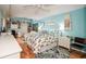 Bedroom with light blue walls, hardwood floors, and built-in shelving at 450 Wexford Cir # 106, Venice, FL 34293