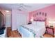 Comfortable bedroom with light wood floors and ceiling fan at 450 Wexford Cir # 106, Venice, FL 34293