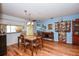 Wood floor dining area with light walls, and a view into the kitchen at 450 Wexford Cir # 106, Venice, FL 34293