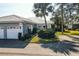 Single-story home with two-car garage and landscaped yard at 450 Wexford Cir # 106, Venice, FL 34293