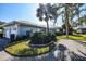 Bright blue house with attached garage and lush landscaping at 450 Wexford Cir # 106, Venice, FL 34293