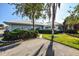 House with palm trees and a well-manicured lawn at 450 Wexford Cir # 106, Venice, FL 34293