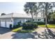Single-story home with two-car garage and landscaped yard at 450 Wexford Cir # 106, Venice, FL 34293