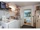 Laundry room with washer, dryer, and access to bedroom at 450 Wexford Cir # 106, Venice, FL 34293