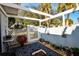Relaxing patio with pergola, gate, and potted plants at 450 Wexford Cir # 106, Venice, FL 34293