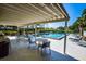 Relaxing community pool area with covered seating at 450 Wexford Cir # 106, Venice, FL 34293