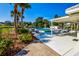 Community pool with lounge chairs and covered seating at 450 Wexford Cir # 106, Venice, FL 34293