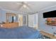 Spacious bedroom with ceiling fan, dresser, and ensuite bathroom access at 460 Base E Ave # 113, Venice, FL 34285
