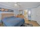 Serene bedroom with light blue walls, wooden dresser and ceiling fan at 460 Base E Ave # 113, Venice, FL 34285