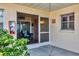 Front door entrance with a screened porch and seating area at 460 Base E Ave # 113, Venice, FL 34285