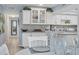 Open concept kitchen with white cabinets and a view into the dining area at 460 Base E Ave # 113, Venice, FL 34285
