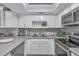 Updated kitchen with gray countertops and white shaker cabinets at 460 Base E Ave # 113, Venice, FL 34285