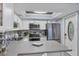 Modern kitchen with stainless steel appliances and white cabinets at 460 Base E Ave # 113, Venice, FL 34285