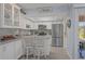 Well-equipped kitchen featuring white cabinets and stainless steel appliances at 460 Base E Ave # 113, Venice, FL 34285