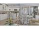 Modern kitchen with white cabinets, stainless steel appliances, and a breakfast bar at 460 Base E Ave # 113, Venice, FL 34285