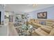Open living area with sectional sofa and view into the kitchen and dining area at 460 Base E Ave # 113, Venice, FL 34285