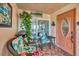 Relaxing patio with wicker chairs and a small table at 460 Base E Ave # 113, Venice, FL 34285