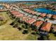Aerial view of community, showcasing homes, streets, and a lake at 482 Montelluna Dr, North Venice, FL 34275