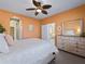 Spacious bedroom with light walls, ceiling fan, and dresser at 482 Montelluna Dr, North Venice, FL 34275