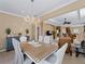 Elegant dining room with chandelier and view into living room at 482 Montelluna Dr, North Venice, FL 34275
