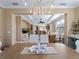 Bright dining room with chandelier and view into spacious living area at 482 Montelluna Dr, North Venice, FL 34275
