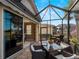 Outdoor patio with seating and view into home at 482 Montelluna Dr, North Venice, FL 34275