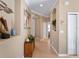 Bright hallway with tile flooring, neutral walls, and decorative wall niches at 482 Montelluna Dr, North Venice, FL 34275