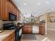 Modern kitchen with granite counters, stainless steel appliances, and breakfast bar at 482 Montelluna Dr, North Venice, FL 34275