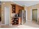 Kitchen features corner cabinet with coffee bar and stainless steel refrigerator at 482 Montelluna Dr, North Venice, FL 34275