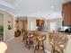 Bright kitchen with granite counters, wood cabinets, and breakfast bar with rattan stools at 482 Montelluna Dr, North Venice, FL 34275